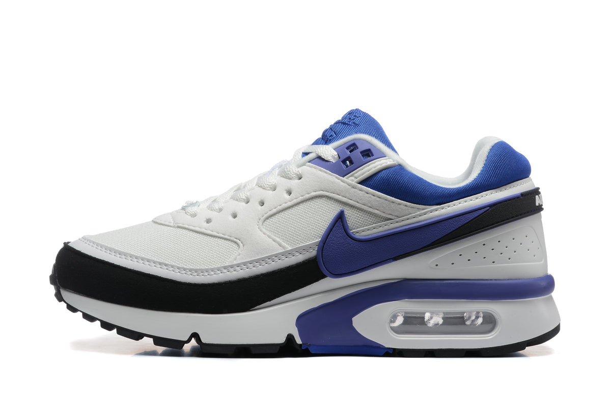 Side view of a white Nike sneaker with blue and black accents, a side Swoosh, and visible heel air unit.