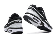 Rear and underside views of black and white Nike Air Max sneakers, showing the heel and outsole.