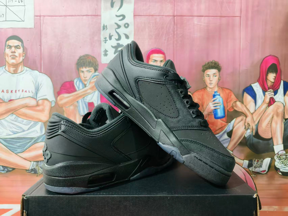Pair of black low-top sneakers shown at an angle on a black box