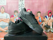 Pair of black low-top sneakers shown at an angle on a black box