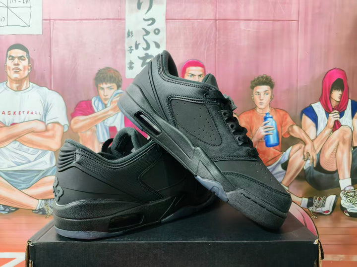 Pair of black low-top sneakers shown at an angle on a black box