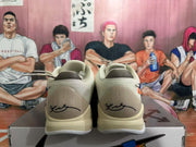 Rear view of white Nike basketball sneakers showing Kobe-style heel signatures, padded collars and light-colored midsoles on a shoebox.