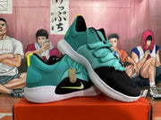 Pair of black and teal Nike basketball shoes with white outsoles