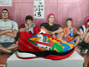 Side profile of a red and multicolor Nike basketball sneaker showing the graphic side panel, black midsole section, and visible Zoom lettering.