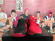 Front view of red and black Nike basketball sneakers with contrasting laces, tongues, and textured toe areas.