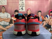 Rear view of red Nike basketball shoes showing number 12 embroidery and contrasting heel details.