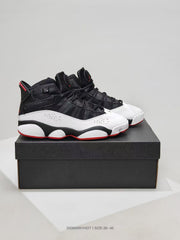 Pair of black, white, and red high-top sneakers displayed on a black shoebox.