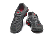 Gray Nike Shox Ride 2 sneakers shown from above, with red accents on the toe and tongue.