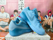 Blue Nike low-top sneakers arranged together, showing the side Swoosh and thick soles.