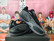 Angled view of black and grey Jordan basketball sneakers showing the patterned side panel, lace-up upper, and rubber outsole.