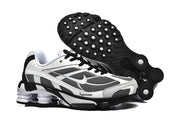 Nike Shox Ride 2 sneakers shown with the black outsole visible, featuring circular tread details.