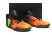 Orange and yellow Kobe 11 pair displayed against a dark background