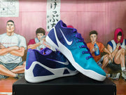 Angled view showing the purple and teal uppers, white Swoosh branding, laces, and layered sole.
