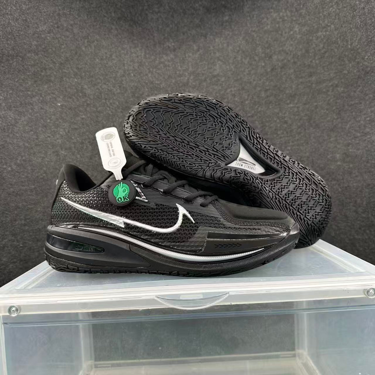 Black and silver Nike basketball sneakers displayed in a side and outsole view.