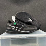 Black and silver Nike basketball sneakers displayed in a side and outsole view.
