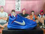 Side profile of a blue Nike Kobe basketball shoe with a silver Swoosh and Zoom marking