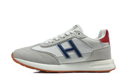 Side profile of a grey and white low-top sneaker with a blue H-shaped side detail.