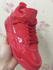 Angled close-up of a red high-top sneaker showing the side mesh panel, laces, and glossy finish.