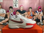 Side view showing the Swoosh logo and red accents on a white Nike basketball shoe