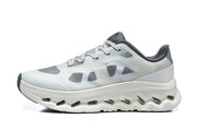 Side profile of a white and grey On Cloudtilt Remix sneaker