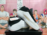 Angled view showing the white side panel, black upper, and purple accents.
