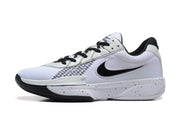 Side profile of a white and black Nike Academy basketball sneaker with a black Swoosh and speckled midsole.