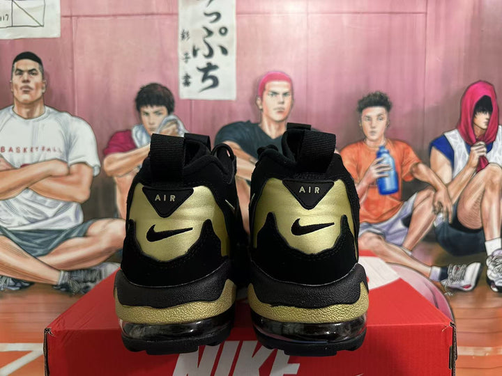 Rear view of black and gold Nike basketball sneakers showing heel branding and visible air units.