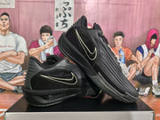 Angled view of two black Nike sneakers showing the contrasting Swooshes, textured uppers, and patterned outsoles.