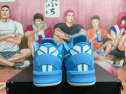 Rear view of blue basketball shoes showing white heel details