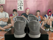 Rear view of grey Nike basketball shoes with white outsoles