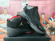 Angled side view of the sneaker pair highlighting the ankle strap, textured side panel, padded heel, and red outsole accents.