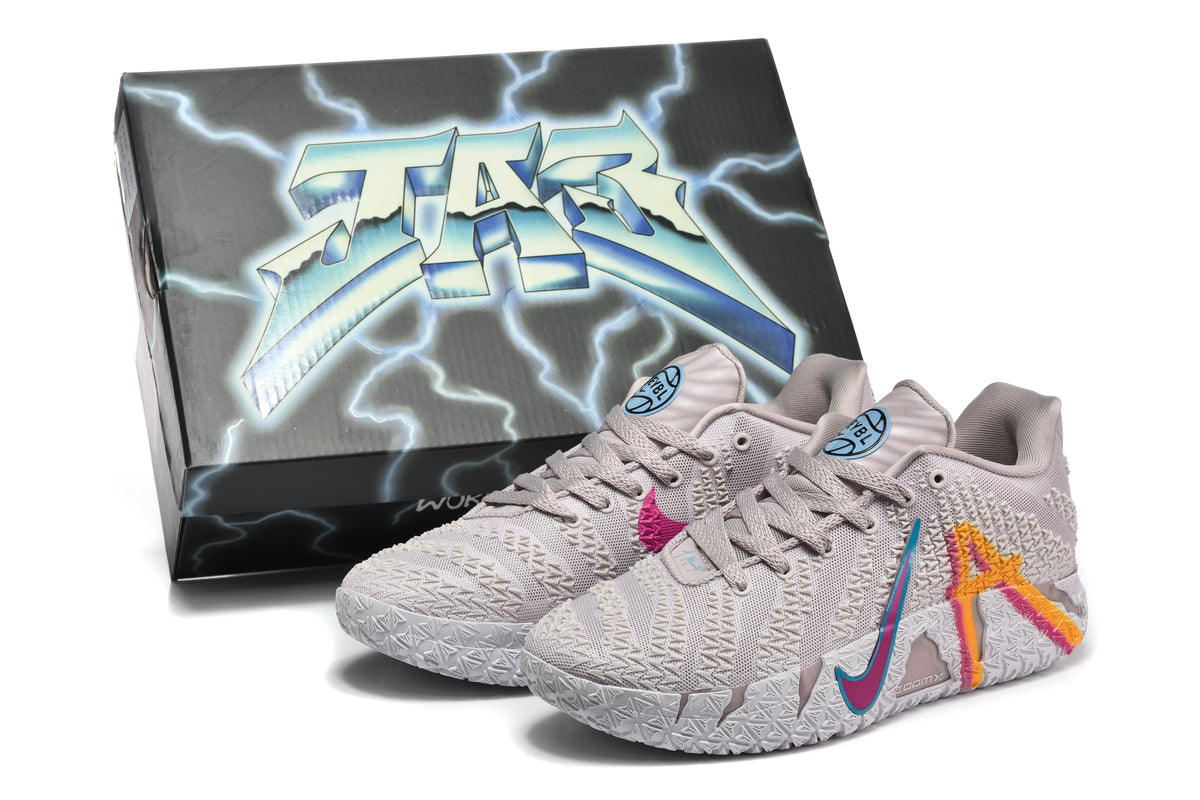 Light gray basketball shoes with colorful side graphics displayed in front of a branded shoebox