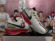 Angled side view showing the white Nike basketball sneakers, black Swoosh, red midsole, and NBA hangtag.