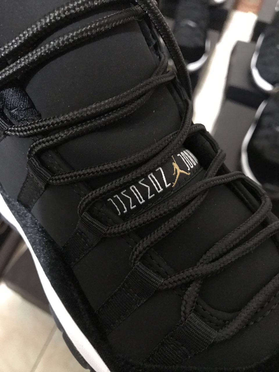Close-up of black laces, padded tongue, and tongue branding on the high-top sneaker.