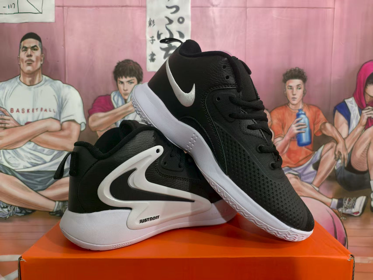 Black and white Nike basketball sneakers shown from a three-quarter side view on an orange box.