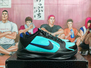Side view of black and turquoise low-top basketball sneakers
