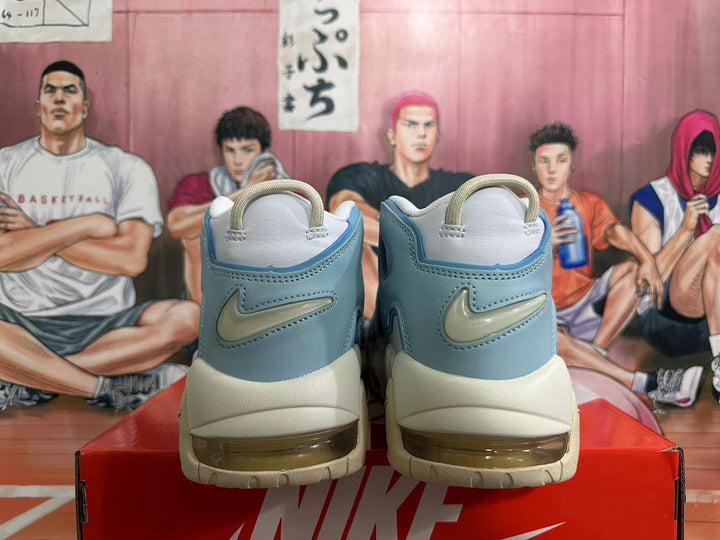 Rear view of off-white and light blue Nike Air More Uptempo sneakers