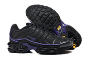 Black and purple Nike Air Max Plus sneakers shown with the patterned outsole visible