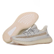 Side view showing the patterned outsole and cream-gray sneaker upper, duplicated from image 2.