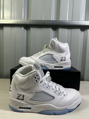Close angled view of the white and silver sneaker pair with mesh panels and 23 details.