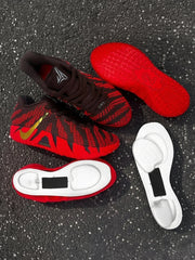 Pair of brown and red basketball sneakers with red patterned outsoles and detached sole components.