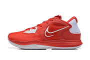Side profile of a red and white Nike Kyrie shoe