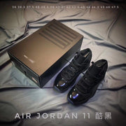 Black Air Jordan 11 sneakers beside a presentation box with a visible size list from 36 to 47.5.
