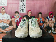 Front view of the pair showing the off-white textured toe boxes, patterned laces, Nike branding, and layered outsole.