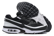 Black and white Nike Air Max sneakers shown from the side and with the treaded outsole visible.