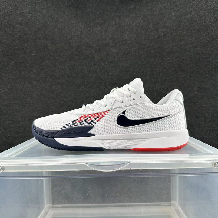Side view of a white Nike low-top sneaker with a navy Swoosh and navy and red accents.