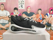 Side view of a black low-top basketball sneaker with a speckled midsole detail.
