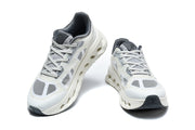 Front and top views of white and grey On Cloudtilt Remix sneakers