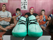 Front view of lake-green basketball shoes with black laces and textured outsoles