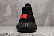 Rear view of a black sneaker showing the textured upper, collar, and ribbed sole.